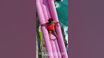 Sliding off a cliff on a GIANT pink inflatable into the CLEAR blue ocean 🤯