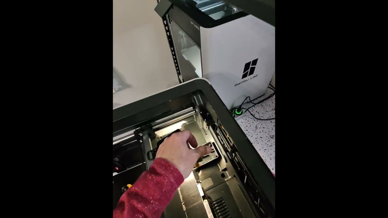 Bambulab H2S adding Teflon tape to the poop chute. 