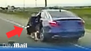 Man clings to moving car door during police chase before being shot as he attempted to flee by Daily Mail 2,640 views 3 days ago 3 minutes, 21 seconds