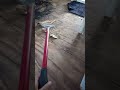 Using Tim's Floor Scraper to remove the remnants of floor vinyl and fire damage. Prep for painting.
