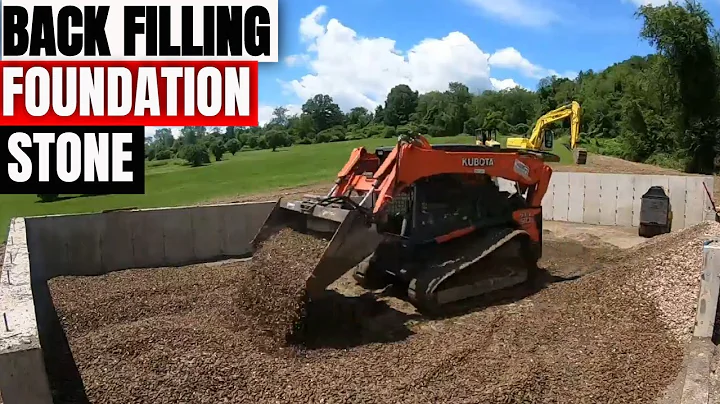 Backfilling concrete footings and walls for a garage with stone using Kubota skidsteer