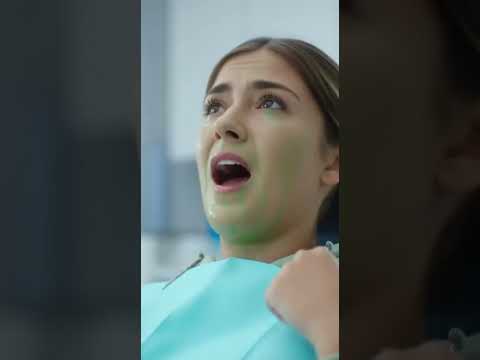 Dentist faces patient who won’t open mouth; splashes mouthwash, she reacts, teeth treatment begins.