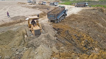 Excellent Big Project Great Talented Expertise Driver Dozer Clearing Dirt with Dump Truck unloading