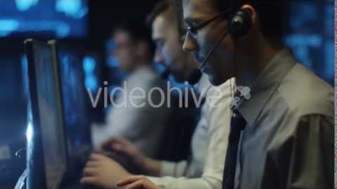 IT Programmers Working on Computer in Headset in Dark Office Room filled | VideoHive 14726051