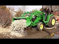 John Deere 3046R First Project, Repair NASTY Driveway with 2 Inch Rock.