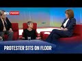 Just Stop Oil protester sits on floor during interview with Kay Burley