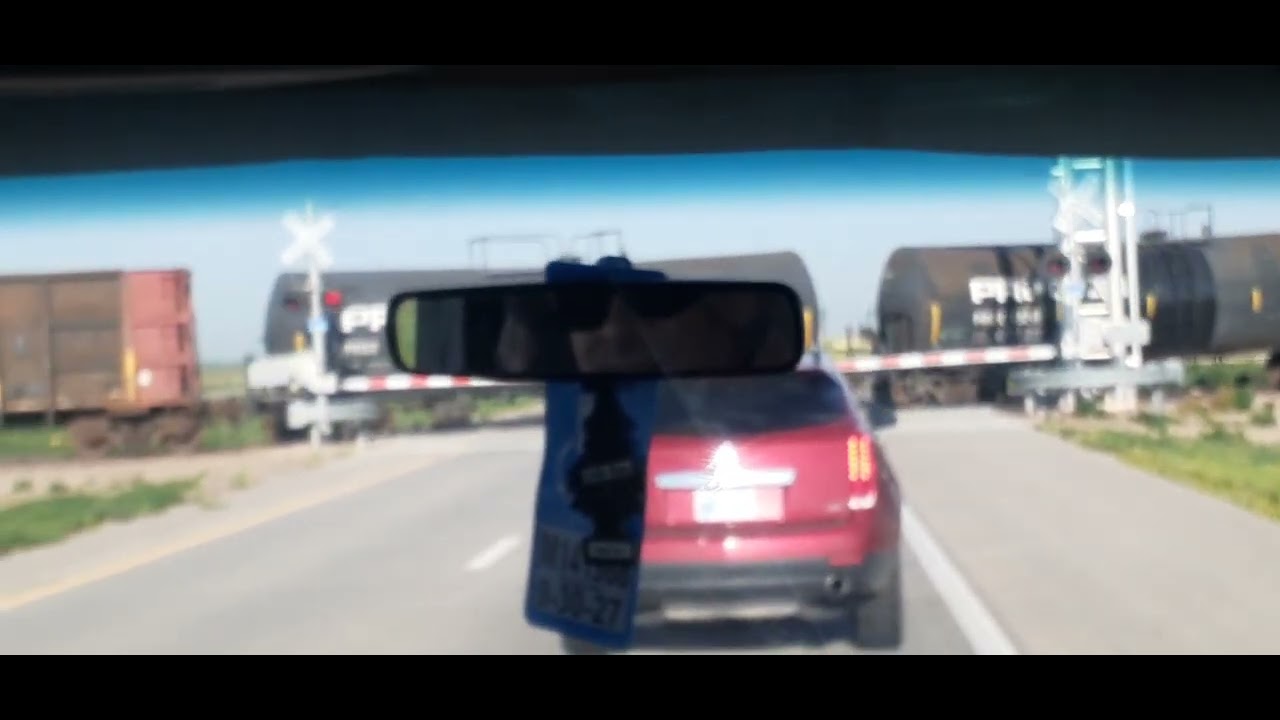 Small train passing through a crossing in middle of Colorado.