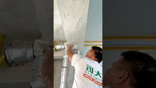 Construction Worker Applying Plaster to a Concrete Beam