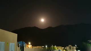 The moon is rising beautifully over the smiling rocks