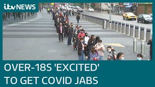 Over-18s 'excited' to get Covid jabs as queues seen outside mass vaccination centres | ITV News