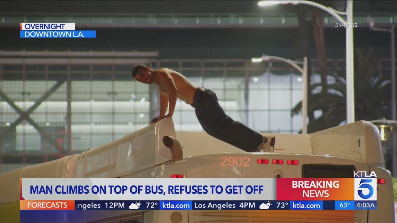 Man climbs on top of bus, refuses to come down for hours in downtown ...