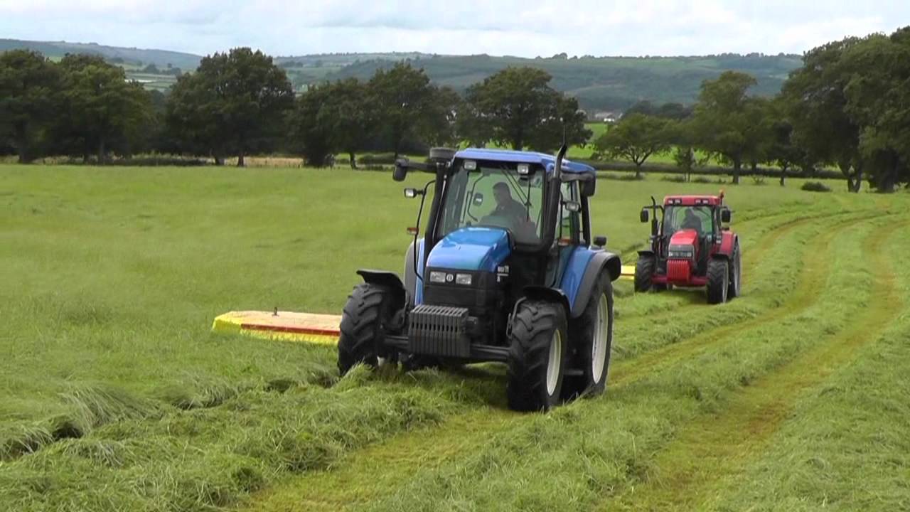 Silage 2011 - Mowing with NH and McCormick.  New Field.