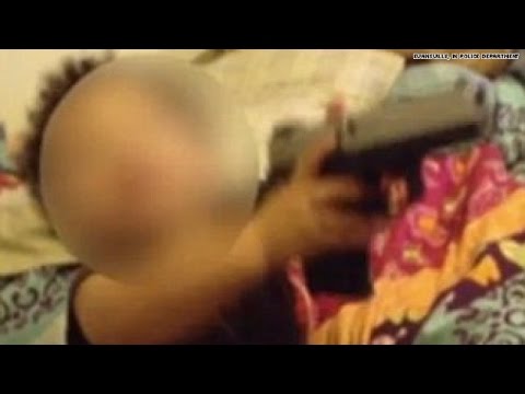 Shocking video shows toddler playing with gun