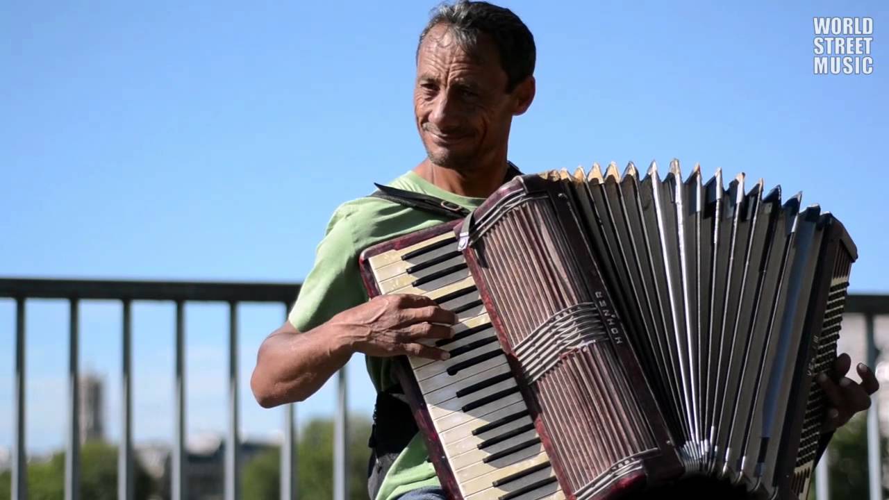 Romanian busker is playing live music on accordion - Katyusha (Paris, France)