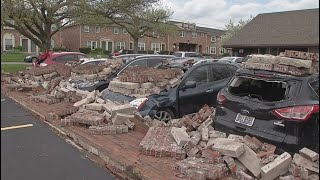 High winds knock over brick wall, damage cars