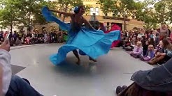 Dancers in ethnic attire dance a folk dance.
