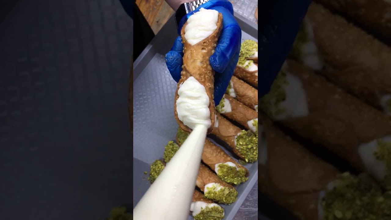 Filling a real Cannoli with a creamy ricotta