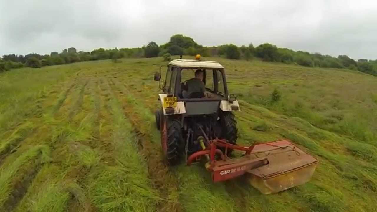 Tractor mowing field YouTube