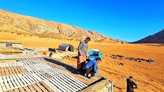 Desert refugees: Covering the roof of the sheep room with boards and materials after a severe storm.