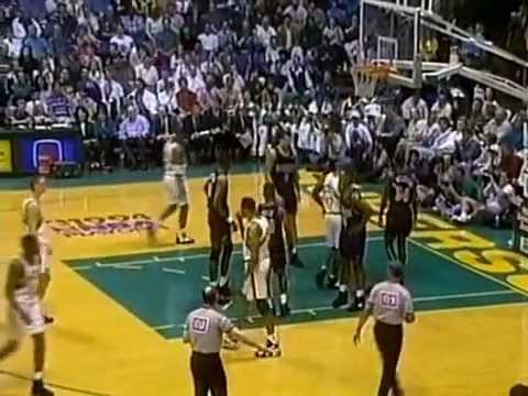 Teammates Mutombo and Williams Get Tangled Up for a Rebound