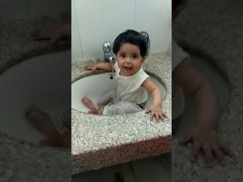1 year old Cute little girl bath in washbasin