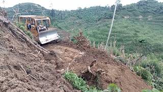 CAT D6R XL Bulldozer opens a new road at the foot of the mountain