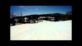 Man skis over puddle in shirt and tie