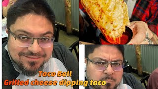 Trying Taco Bell’s new grilled cheese dipping taco.