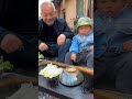 Tongguan roujiamo grilled enoki mushrooms on stone slab