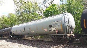 NS ES40DC #7678 leads a freight train headed westbound with 4 engines