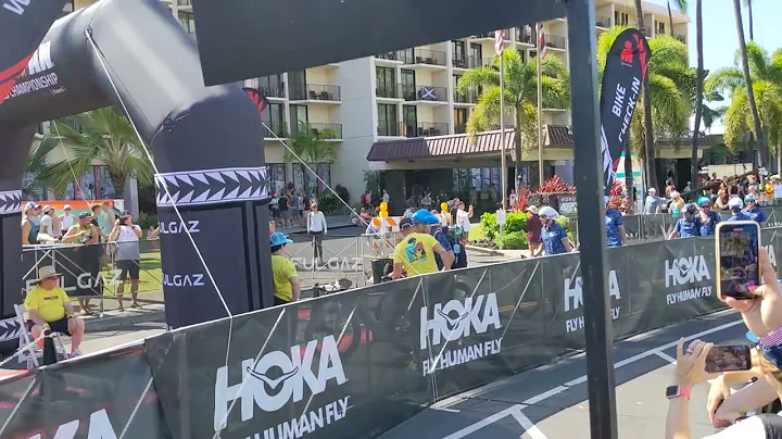 emj TRI team walking into rack bikes, Kona '22