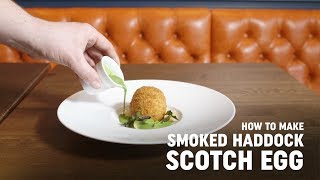How to Make, Smoked Haddock Scotch Egg, with Steven Ellis
In this videos Steven Ellis of the Oxford Blue shows us his new take on some old classics, the fishcake and scotch egg. This inventive recipe is both hearty and delicious.
Recipe
Ingredients
Serves 4
4 medium hens eggs
200g smoked haddock which has been cooked in ½ milk, ½ cream
200g potato (boiled in water & mashed)
Salt and pepper
100g flour
3 eggs beaten
500g breadcrumbs
To make scotch eggs
Bring a pan of water to the boil,add a pinch of salt,cook the hens eggs for 5 mins then place directly into iced water
Allow to cool then peel and set to one side
For the farce mix together the picked haddock, mashed potato, a pinch of parsley and season to taste with salt and pepper, Split the mixture into 4 even pieces the size of golf balls.
Lightly flour your hands and spread the mix in the palm of your hand, place the egg in the centre and wrap the meat around to form a ball,repeat this process with all the remaining eggs
To coat the scotch eggs, place the seasoned flour in a bowl and set a side, repeat this process with both the beaten eggs and bread crumbs.
Flour all the eggs then individually coat in the beaten egg and finish by rolling in the breadcrumbs ( In the trade we call this to pane)
Deep fat fry for 3 minutes at 180 degrees
Then finish in the oven for 5 minutes at 180 degrees
Served with confit lemon slices and a watercress velouté. How to Make, Smoked Haddock Scotch Egg, with Steven Ellis
