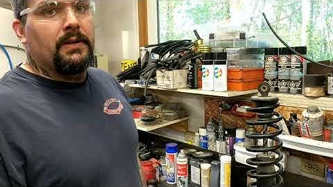 Spring compressing without a spring compressor