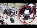 Bystanders and Police Lift Car Off Trapped Motorcyclist