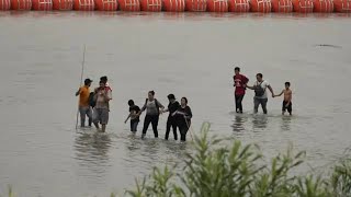 Biden administration sues Texas governor over Rio Grande buoy barrier that's meant to stop migrants