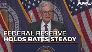 Federal Reserve holds rates steady, signals cuts ahead
