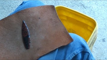 118 - Flintknapping a slab of red and black obsidian. 1/2