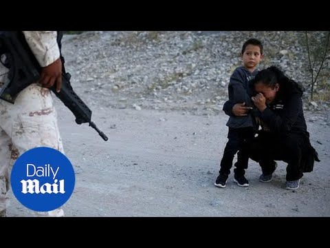 Guatemalan mother begs armed solider to let her cross into U.S.
