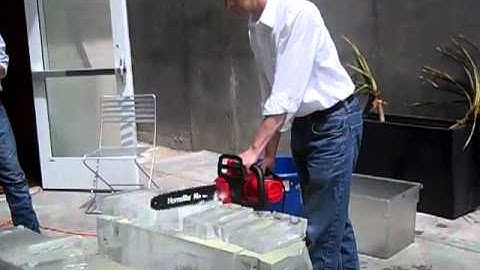 Erik Ellestad cuts ice block with a chainsaw