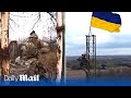 Ukraine border guards hoist flag in Budarky after soldiers battled north of Kharkiv