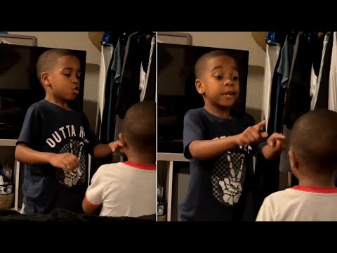 Big brother helps little brother calm down with breathing exercise