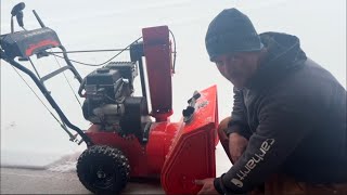 SNOW BLOWER ON A GRAVEL DRIVEWAY