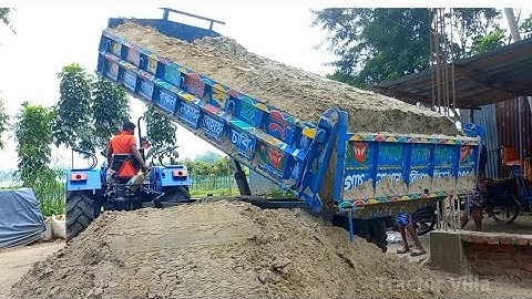 Excavator loading river Sand on tractor By Unloading digital hydraulic system on charming roads side