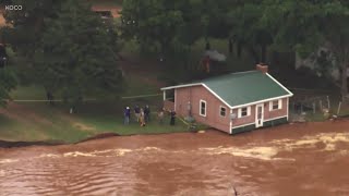 Homes Left Dangling Over Raging River After Currents Erode Riverbank