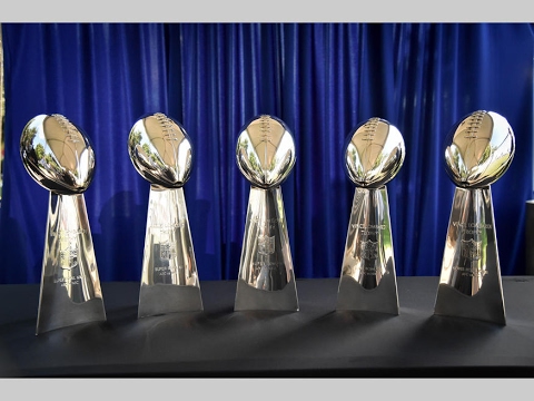 GRONK TRIES TO CARRY ALL 5 SUPERBOWL TROPHIES 