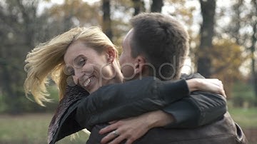Happy couple hugging in the park, slow motion, shot at 240fps HD. Stock Footage