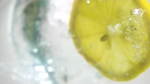 Lemon Slice Falling Into Water Stock Video