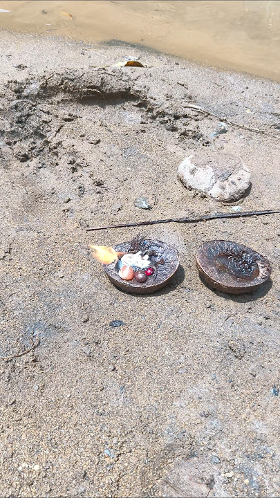 A black object that looks like a Pokemon ball comes out of the river with fire, apparently it con...