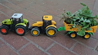 two tractors pulling trolley