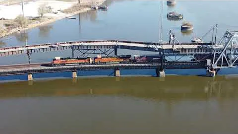 Ft. Madison Iowa, Westbound BNSF crossing swing bridge and catching Amtrak EB on Illinois side.